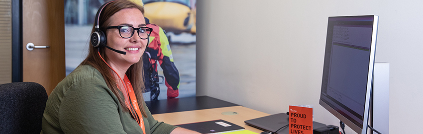 Survitec administrator in fron of monitor