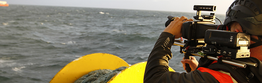 Videographer filming the sea