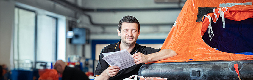technician in front of liferaft